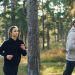 Man and woman jogging together in a park.